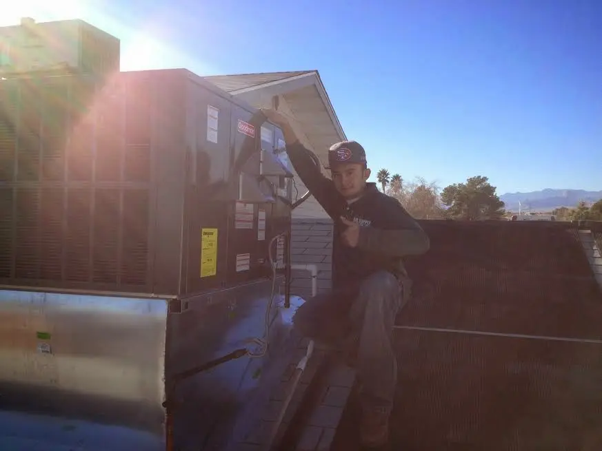 HVAC technician performing HVAC Inspection on a rooftop unit in Granville